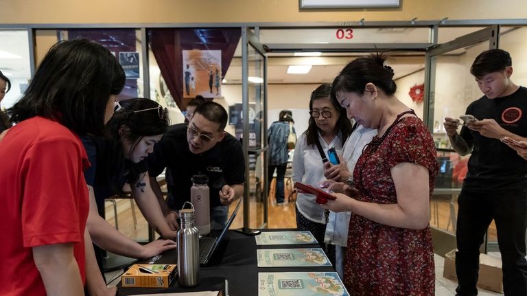 Members of the Las Vegas Asian community receive information on...