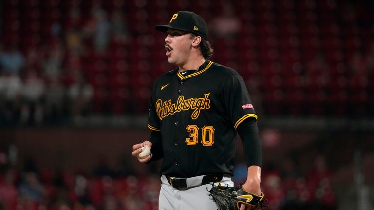 Pittsburgh Pirates starting pitcher Paul Skenes pauses after giving up...