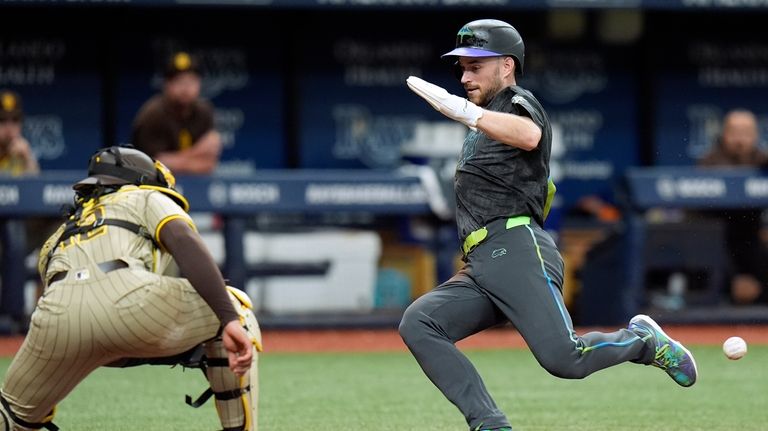 Tampa Bay Rays' Brandon Lowe, right, prepares to score ahead...