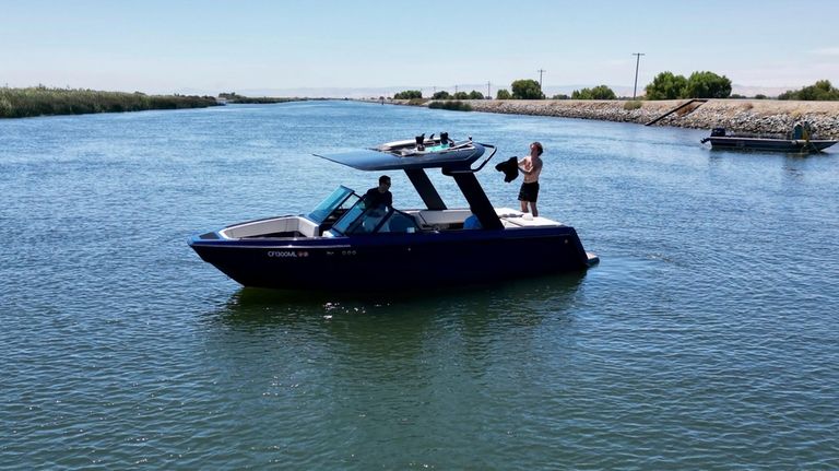 An electric sports boat made by California-based Arc Boats floats...