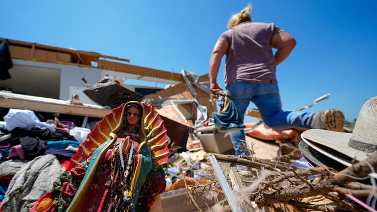 A Guadalupe Virgin statue is seen in the destroyed home...