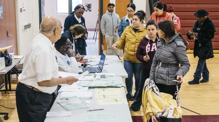 Voters check in at a polling site for Michigan's primary...