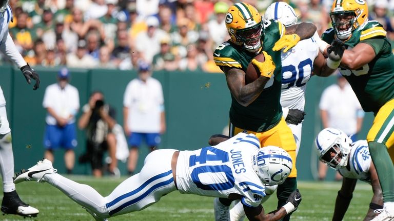 Green Bay Packers running back Josh Jacobs (8) is brought...