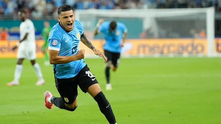 Uruguay's Maximiliano Araujo celebrates after scoring his side's opening goal...