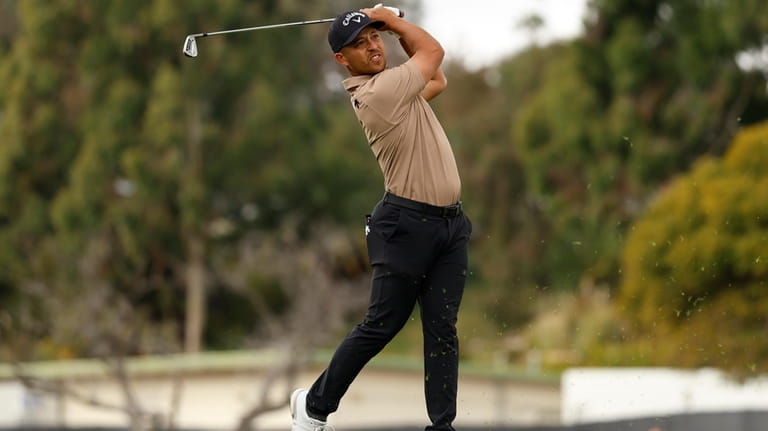 Xander Schauffele his from the first tee during the final...