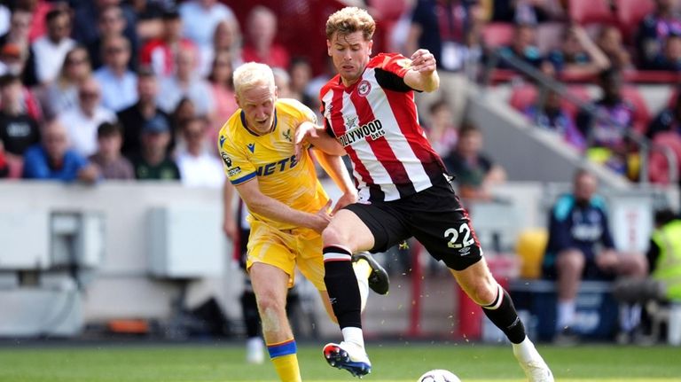 Crystal Palace's Will Hughes, left, and Brentford's Nathan Collins battle...