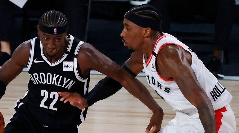 Nets' Caris LeVert drives against Toronto Raptors' Rondae Hollis-Jefferson during...