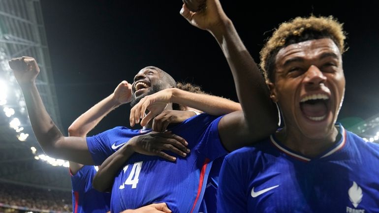 France's Jean-Philippe Mateta(14), left, celebrates with teammates after scoring his...