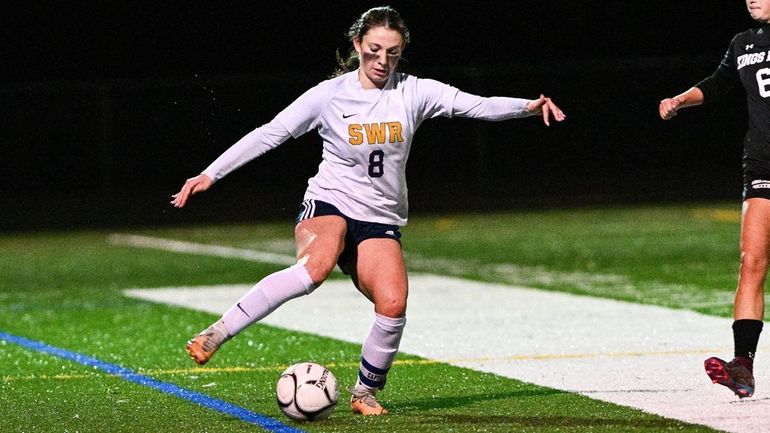 Grace Hillis of Shoreham-Wading River takes control of the ball...