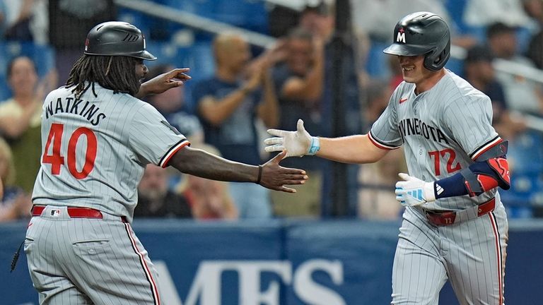 Minnesota Twins' Brooks Lee (72) celebrates with third base coach...