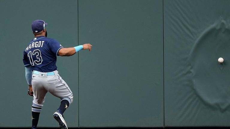 Tampa Bay Rays center fielder Manuel Margot chases after a...