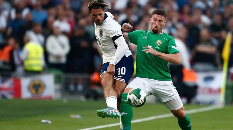 Ireland's Matt Doherty, right, vies for the ball with England's...