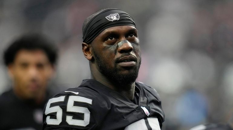 Las Vegas Raiders defensive end Chandler Jones warms up before...