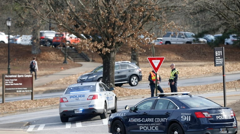 Athens-Clarke County police block traffic and investigate at the UGA...