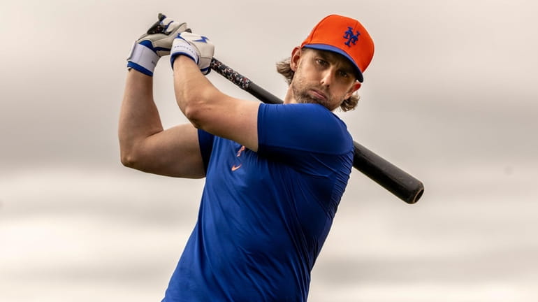 Mets infielder Jeff McNeil swings during a spring training workout...