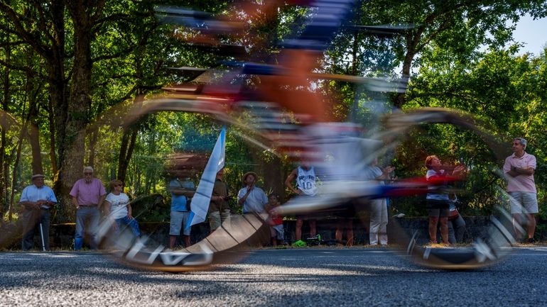 People watch the twelfth stage of La Vuelta between Ourense...