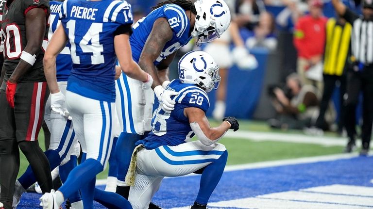 Indianapolis Colts running back Jonathan Taylor (28) kneels as he...