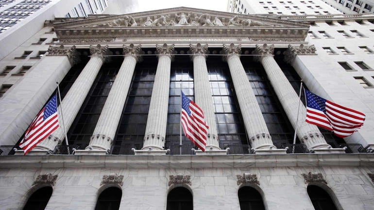 American flags fly in front of the New York Stock...