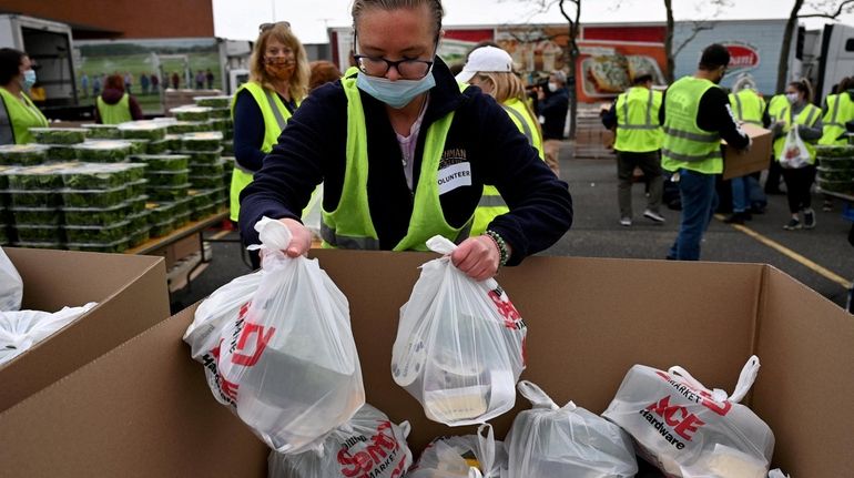 Island Harvest Food Bank hosted a food distribution drive in...