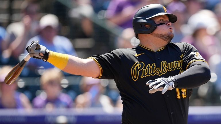 The Pirates' Daniel Vogelbach strikes out against Rockies relief pitcher...