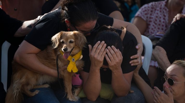 Rimon Buchshtab, center, mourns during the funeral of her husband...