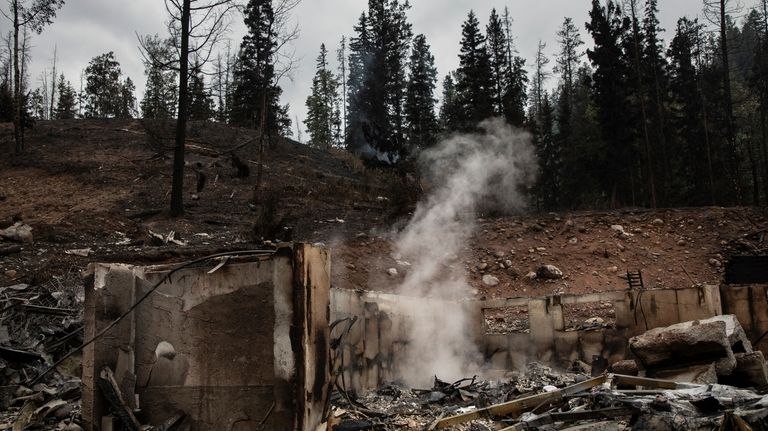 The remains of a home smoulder in Jasper, Alta., on...