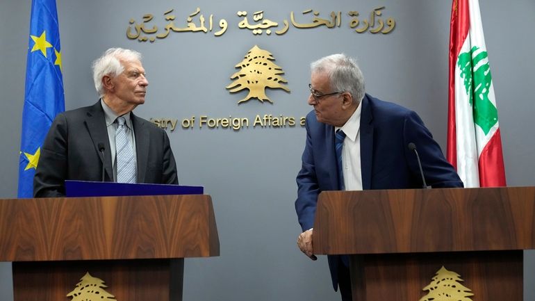 Lebanese Foreign Minister Abdallah Bouhabib, right, looks at the European...