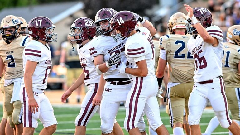 Anthony Asaro of Garden City is congratulated by his teammates...