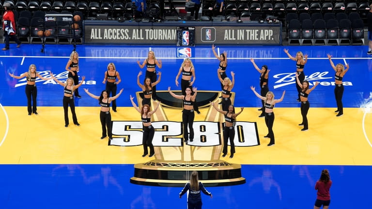 Denver Nuggets cheerleaders practice on the new floor installed for...
