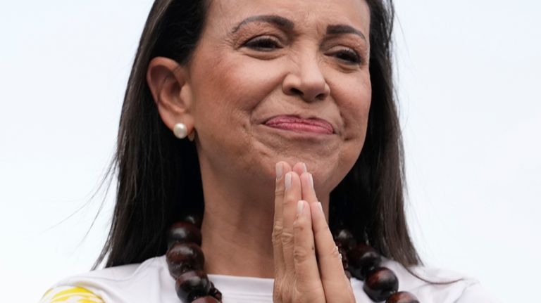 Opposition leader Maria Corina Machado, gestures during a closing election...