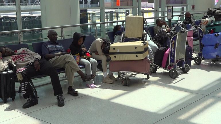 Passengers at JFK airport Wednesday after a software glitch delayed...