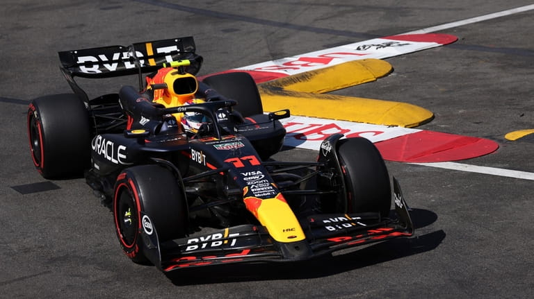 Red Bull driver Sergio Perez of Mexico steers his car...
