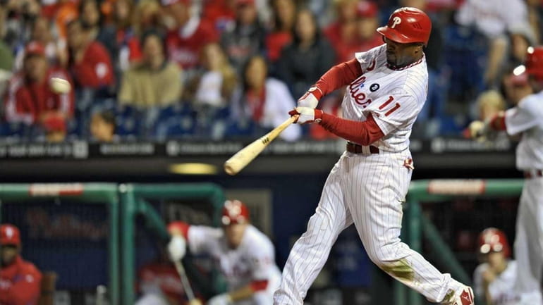 Jimmy Rollins of the Philadelphia Phillies hits a triple in...
