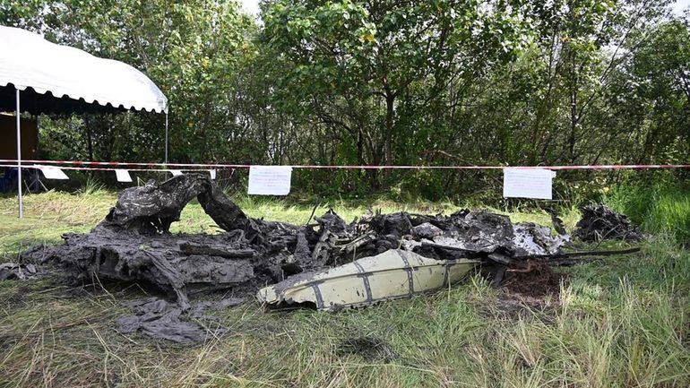 The wreckage of a small passenger plane that crashed on...