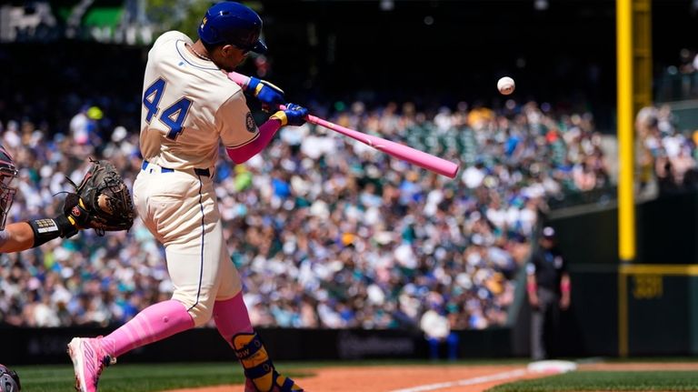 Seattle Mariners' Julio Rodríguez hits a double against the Oakland...