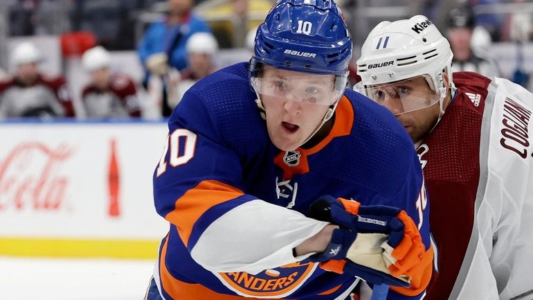 Simon Holmstrom #10 of the Islanders skates against Andrew Cogliano...