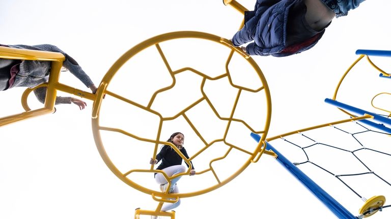 Bella Varelakis enjoys the playground at John J. Burns Park in Massapequa...