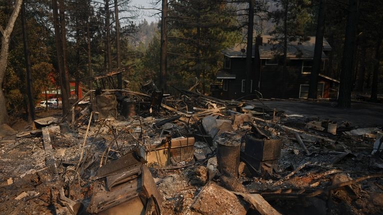 A fire-ravaged property is seen after the Bridge Fire swept...