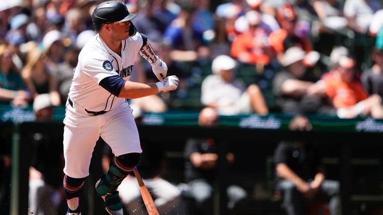 Seattle Mariners' Ty France watches his single against the Baltimore...