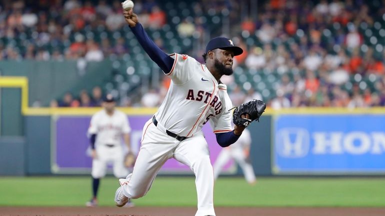 Houston Astros starting pitcher Cristian Javier throws to a Los...