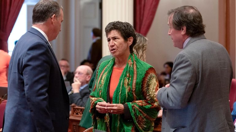 State Sen. Susan Talamantes Eggman, of Stockton, center talks with...