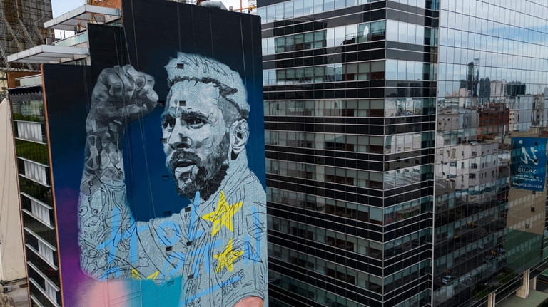 A mural depicting soccer legend Lionel Messi, by artist Martin...