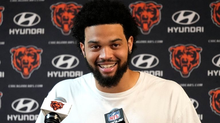 Chicago Bears quarterback Caleb Williams meets with reporters after his...