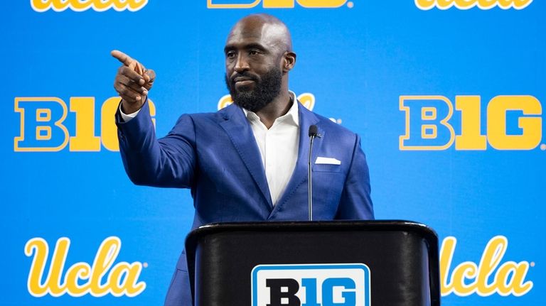 UCLA head coach DeShaun Foster talks with reporters during an...