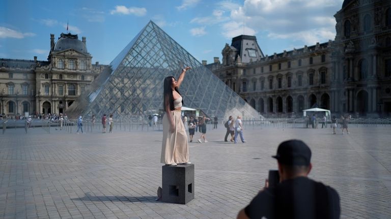 A woman from Mexico poses in the courtyard of the...