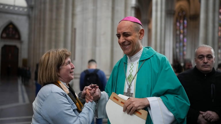 Monsignor Victor Manuel Fernandez, archbishop of La Plata, holds hands...
