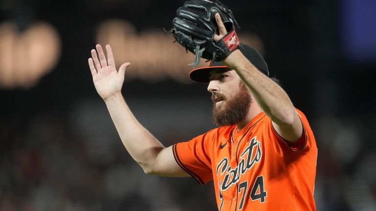 San Francisco Giants pitcher Ryan Walker (74) reacts after the...