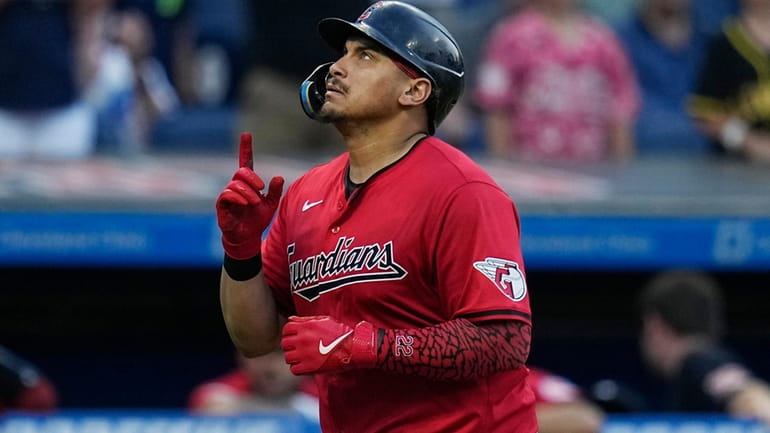 Cleveland Guardians' Josh Naylor gestures as he runs to home...