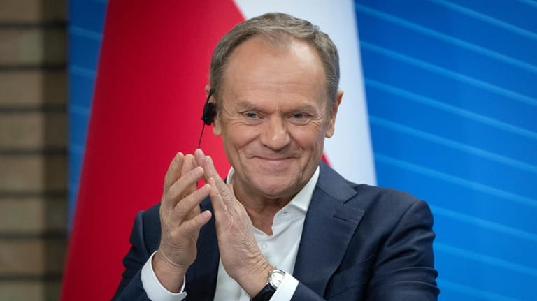 Poland's Prime Minister Donald Tusk reacts during his and Ukrainian...