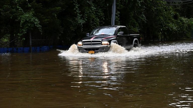 Port Jefferson is heavily flooded as the the remnants of...